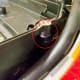 Disconnect air suction hose from side of air cleaner housing (circled in red) .
