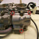 Remove three screws that hold the float bowl in place (circled in red).