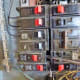 Removing a breaker. A screwdriver is being used to carefully pry up the side in the center of the panel.