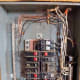 Inside a panel. This panel has no main breaker. The ground bus is on the left, with the neutral bus on the right.