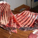 Make angle cuts, as shown, near the spine or cut into suitable pieces for feeding. Start at the front of the back of the ribcage, whichever is easier.