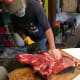 We prefer steaks over roasts, so cut along an imaginary line between the good and "junk" meat, or where the steaks stop and thinly covered ribs begin.