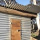 If we need access to the inside of the chicken house, we don't have to enter the chicken run. Recycled wood for door and laying boxes needs painting. The roofing iron yet to be finished.