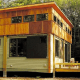 In this installed Ready Structures cottage, the exterior features fiber cement board (low maintenance), full-width wood deck, and plenty of windows.