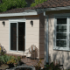 Careful exterior and roof choices made this cottage match the adjoining house.