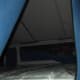 This tent trailer has a raised bed area that can safely zip closed so even young children can't accidentally fall out. There's also room for more beds within the main tent area.
