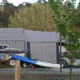 The first time I saw a tent trailer erected, I was amazed by its size and space. See the tiny trailer buried within this large tent? These are a lot cheaper than you'd expect.