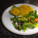 Stuffed bell pepper with crispy rice greens and shredded carrot.