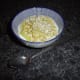 Bowl of natural yoghurt with stewed apple and toasted oats.