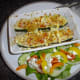 Stuffed courgette with feta cheese gratin and salad.