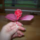 Stick the lollipop through the holes.