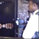 This photo is a reenactment of a young W.C. Handy (guitar in hand) demonstrating his new blues song entitled "Mr. Crump Blues" to a receptive auidence. (Reenactment)
