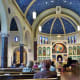 View from the back looking towards the altar inside of All Saints Catholic Church