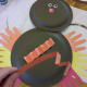 Bend orange strips of construction paper back and forth to create the turkey legs.
