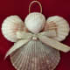 A little spray adhesive glitter, a little glue, a pretty bow and a faux pearl make a pretty pink seashell angel Christmas ornament.