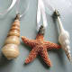 Top with silver or gold filigree caps from a hobby or craft store and thread with decorative ribbon or metallic cord.