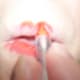Draw a doll-shaped mouth on with red makeup.