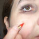 Use the red makeup for rosy cheeks. Apply as a circle and then smudge it.