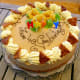 Cookies, frosting flowers, and fun candles decorate this cake.