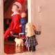Sisters watch their new guest from the safety of the kitchen.