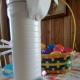 Glue the ears to the back of the canister just below the lid. Add the tail, whiskers, nose, eyes, and other features. Draw on the mouth.