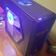 The Tesseract comes with 2 blue LED fans. They are somewhat bright, but don't feel like a nuisance.