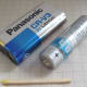 CRV3 3 volt non-rechargeable lithium battery alongside an AA cell for size comparison.