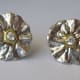 Fine silver earrings textured with a mold made from a tangerine blossom and embellished with cubic zirconia chatons and 22k gold (Aura 22).
