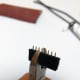 Using the cutting pliers, cut at the middle of the 5th pin if you're building a 4-pin connector. General rule: cut at the n + 1/2 pin for a connector with n pins.