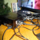 Above: the three optical audio cables from various devices, plugged into the back of the optical audio switch, and the out optical audio link to the sound system. Below: all the cables for the TV plugged into the TV’s One Connect box.
