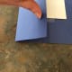 Fold the outside edges in to line up with center crease. Do the same with the top and bottom edges and tape them all down if it all looks good on the viewing side.