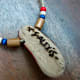 The finished pendant was left to dry and then strung on a natural colored leather cord along with some accent colored wooden beads.