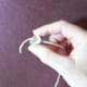 After priming your wick by dipping it in melted wax, feed it through the hole in your wick anchor.