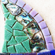 Along with glass tiles and cut glass, the artist used abalone shells, jewels, broken pottery and stones in her mosaic.