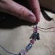 5. You can use a piece of wire or a toothpick to pull your final knot up close to the last bead. Be sure to double knot.