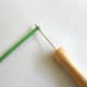 Insert one end of quilling paper into the slit of quilling tool.