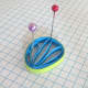 A fan-shaped husking with a different colour paper strip around it.