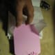 Cut corners of cardstock into tag shape, punch hole and then put yarn through and tie