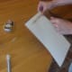 Attach a wooden stick with tape to back of flag.
