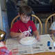 Spread out coffee filters on paper plates and paint them red and blue.
