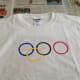 Wash and dry jar, then dip in yellow paint to print the fourth ring interlocking with the blue and black rings as shown.