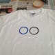 Wash and dry jar, then dip in blue paint to print the second ring 1/2 inch to the left of the black ring.
