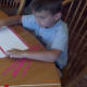 Glue red stripes on white construction paper.