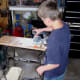 Sanding the surface of each board with a palm sander.