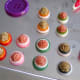 Stacked button pairs with plastic flower cabochons waiting to be made into button hair pins.