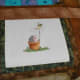Assembling the fabric frame around the cross stitch, one layer at a time.