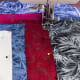 Sew 'in the ditch' with a walking foot, following the lines of the framing fabrics.