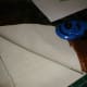 Assembling the layers - first calico, then batting, finally the cross stitch on top, design facing up.