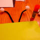 Add the black pipe cleaners and white pom poms to the top of the bag.