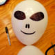 Use a permanent black marker to create the face.